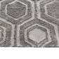 Bruin geometrisch vloerkleed met hexagon patroon voor woonkamer.